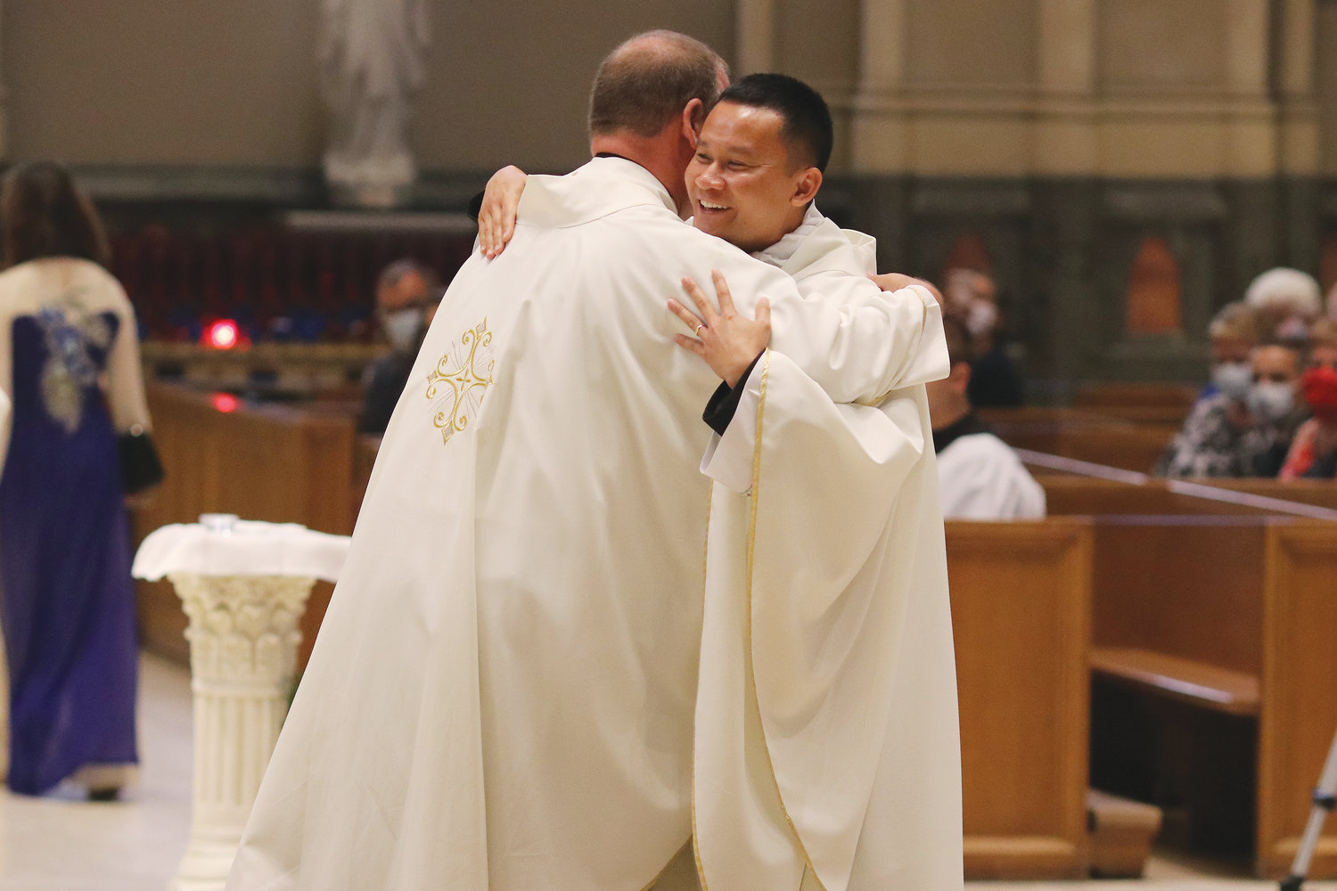 Msgr. Albert A. Kenney embraces his newest brother priest.
